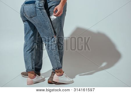 Cropped View Of Couple Hugging While Man Holding Condom In Hand