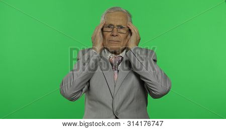 Elderly Businessman In Suit Suffer By Headache Pain Trouble. Old Senior Man In Formal Wear On Chroma