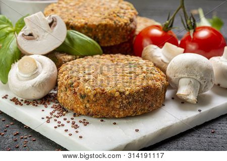 Tasty Vegetarian And Vegan Burgers Made From Healthy Quinoa, Basil, Tomatoes And Champignon Mushroom