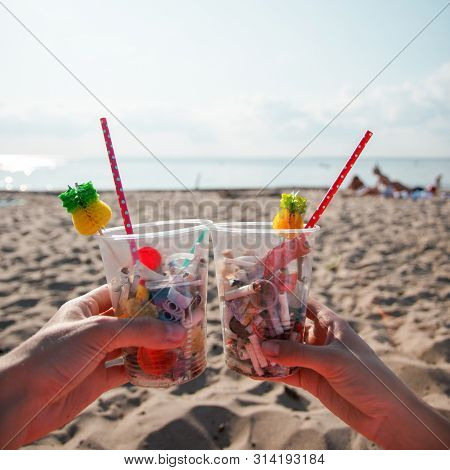 Plastic Pollution In Ocean Environmental Problem, Hands Holding Plastic Cups With Straws And Cocktai