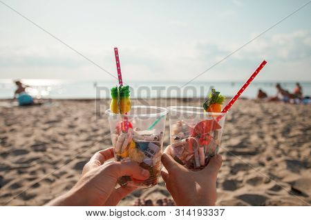 Plastic Pollution In Ocean Environmental Problem, Girls Hands Holding Plastic Cups With Straws And C