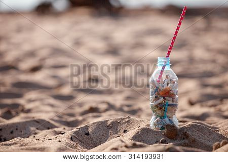 Cocktail With Garbage And Straw On Clean Beach. Plastic Ocean Pollution, Environmental Crisis. Say N