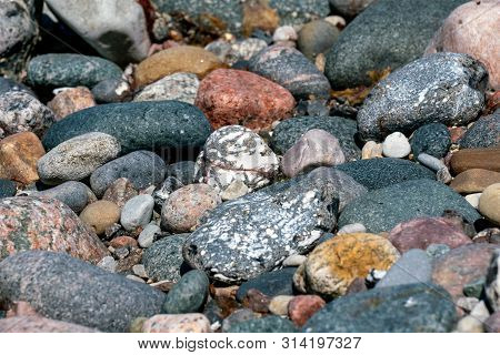 Multi Coloured Pebbles On A Beach In Bright Sunshine