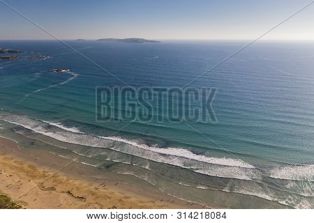 Ocean Waves, Sandy Beach With People Bathing In The Water, View From Drone, Lanzada Beach, Galicia,