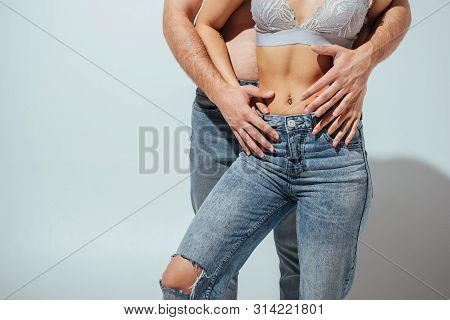 Cropped View Of Naked Man And Muscular Girl Hugging On White