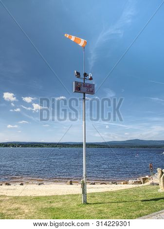 Ferry Pier With Windsock At The Shore Of Lipno Lake, Gentle Wind.  16th Of July 2019, Lipno Lake Cze