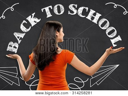 Half-length Close Up Portrait Of Young Hindoo Woman In Orange Dress On Dark Background. Human Emotio