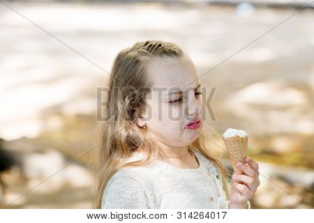 It Leaves A Bad Taste In The Mouth. Cute Little Girl Dislike Taste Of Ice Cream. Small Child Licking
