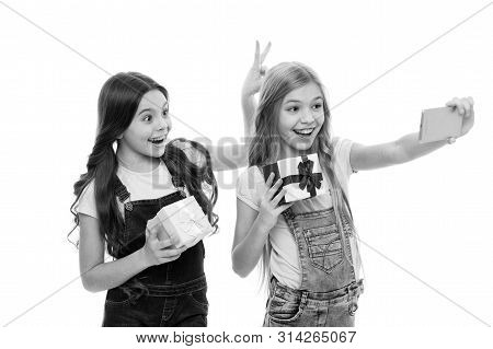 Posing As Models. Small Fashion Models Taking Selfie On Smartphone. Little Photo Models With Gifts C
