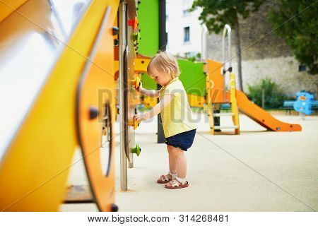 Adorable Toddler Girl Near Playground Slide. Outdoor Activities For Kids