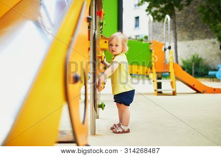 Adorable Toddler Girl Near Playground Slide. Outdoor Activities For Kids