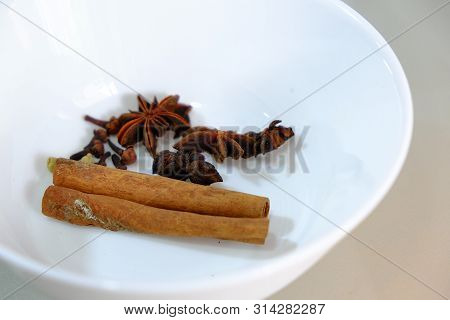 Cinnamon And Star Anise Placed In A White Bowl.
