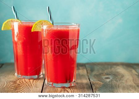 Watermelon Slushie With Lime And Mint, Summer Refreshing Drink In Tall Glasses On A Light Blue Backg