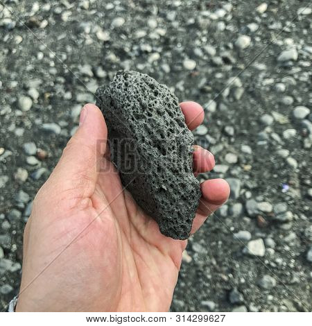 Person Holding Chunk Of Volcanic Rock In Iceland