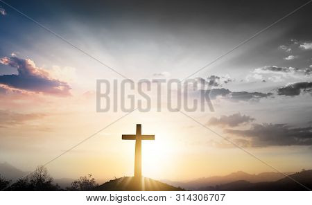 Christmas Concept: The Cross On Mountain Sunset Background