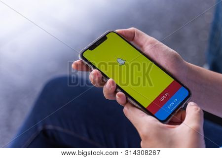 Chiang Mai, Thailand - Jul.27,2019: Holding Iphone Xs With Social Network Service Snapchat On The Sc