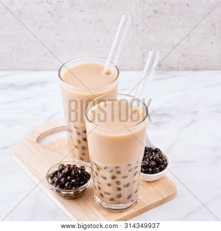 Tapioca Pearl Ball Bubble Milk Tea, Popular Taiwan Drink, In Drinking Glass With Straw On Marble Whi