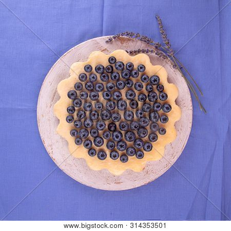Homemade Cheesecake Decorated With Blueberry Over On Fabric. Top View