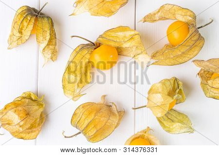 Physalis Fruit (physalis Peruviana) On A White Wooden Background Close-up. Cape Gooseberry.  Minimal