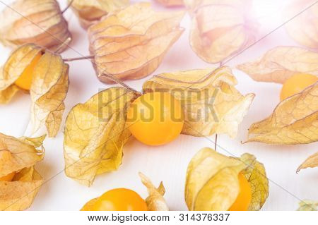 Physalis Fruit (physalis Peruviana) On A White Wooden Background Close-up. Cape Gooseberry.  Minimal