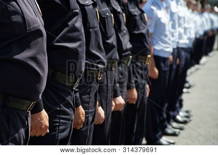 A Squad Of Russian Police Officers Stands On A City Street Or Square. Problems Of Opposition Rallies