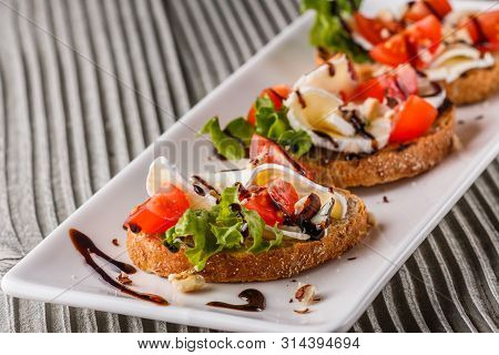 Bruschetta With Tomatoes, Lettuce, Camambert, Balsamic Vinegar
