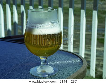A Glass Of Beer With A Collar.