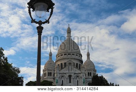 The Basilica Sacre Coeur Is A Roman Catholic Church Located At The Summet Of The Butte Montmartre , 