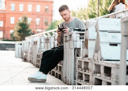 Young Handsome Man With Drone Quadcopter Joystick Controller At Urban Background.