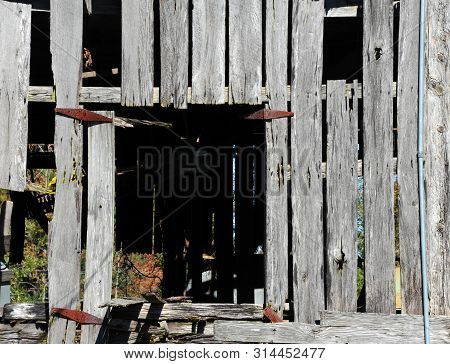 Loft In Derelict Barn Is Missing Its Door.  Rusty Hinges Mark Where Door Would Have Been.  Opening I