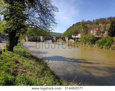 View Over The Werra River In Hann. Munden, Germany To The Old Stone Bridge