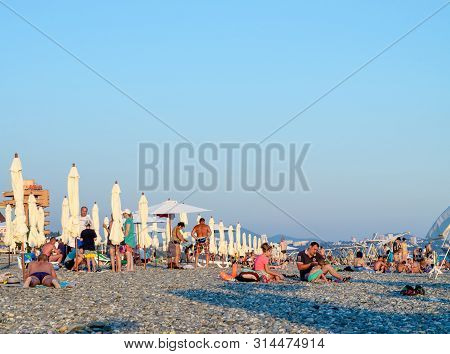 Sochi, Russia - July 7, 2019: People On The Beach Of Dagomys In The Evening