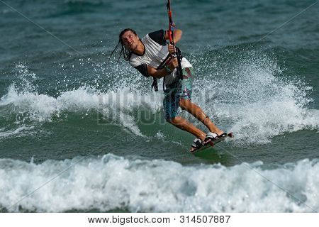 Kitesurfing on the waves of the sea in Mui Ne beach, Phan Thiet, Binh Thuan, Vietnam. Kitesurfing, Kiteboarding action photos Kitesurfer In action