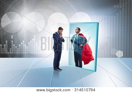 Businessman seeing himself in mirror as superhero
