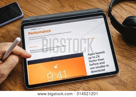 Paris, France - Jun 6, 2019: Man Reading On Apple Ipad Pro Tablet About Latest Announcement Of At Ap