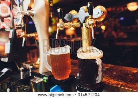 Close Up Of Beer Taps In Row. Metallic Equipment For Bars And Mini Brewerys. Concept Of Modern Equip