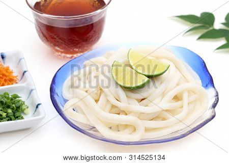 Japanese Chilled Udon Noodles In A Glass Plate With Mentuyu On White Background