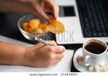 Unhealthy Snacking, Eating Junk Food At Workplace. Hands Of Woman Working At Computer And Taking Chi