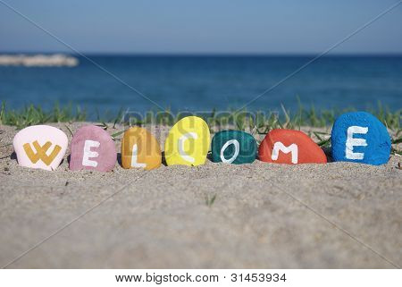 welcome concept on colourful pebbles