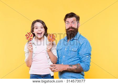 Sharing Sweets With Dearest People. Daughter And Father Eat Sweet Candies. Sweet Childhood. Girl Chi