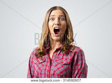 Scared Young Woman Screaming With Panic. Emotional Girl Has Frightened Facial Expression. Portrait O