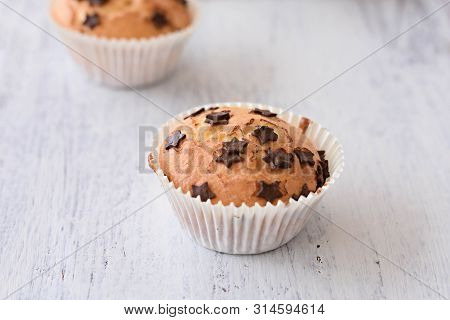 Sweet Delicious Homemade Vanilla Muffins Whit Chocolate Chips At White Wooden Background