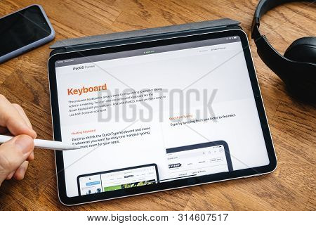 Paris, France - Jun 6, 2019: Man Reading On Apple Ipad Pro Tablet About Latest Announcement Of At Ap