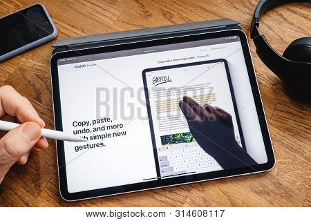 Paris, France - Jun 6, 2019: Man Reading On Apple Ipad Pro Tablet About Latest Announcement Of At Ap