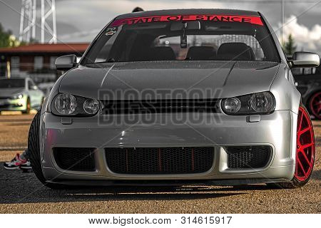 Moscow, Russia - July 19, 2019: Tuned Low Sport Hatchback With Red Candy Colored Alloy Wheels. Volks