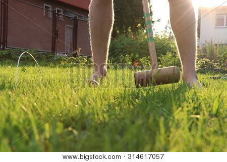 Young Boy Is Playing Cricket On The Garden. Missing Last Goal. Game During Sunset. Wooden Stick With