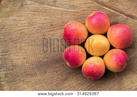Apricots On Wooden Background Assembled In The Form Of Flower, Flat Lay Photography