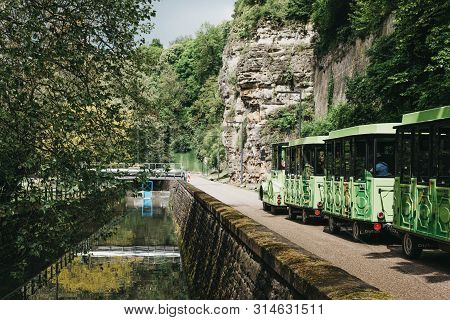 Luxembourg City,luxembourg - May 19, 2019: Citytrain Going Past Petrusse River In A Park In Luxembou