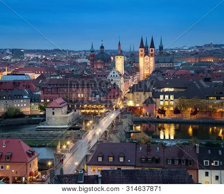 Wurzburg, Germany. Aerial Cityscape At Dusk With Alte Mainbrucke Bridge