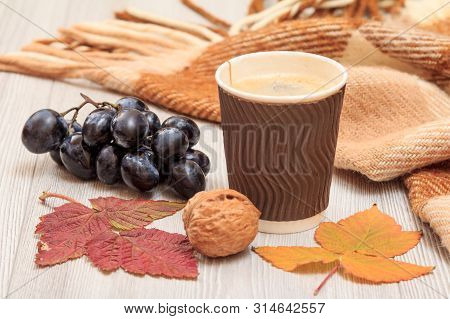 Grapes, Cup Of Coffee, Walnut, Checkered Plaid And Dry Leaves On Wooden Boards. An Autumn Still Llif